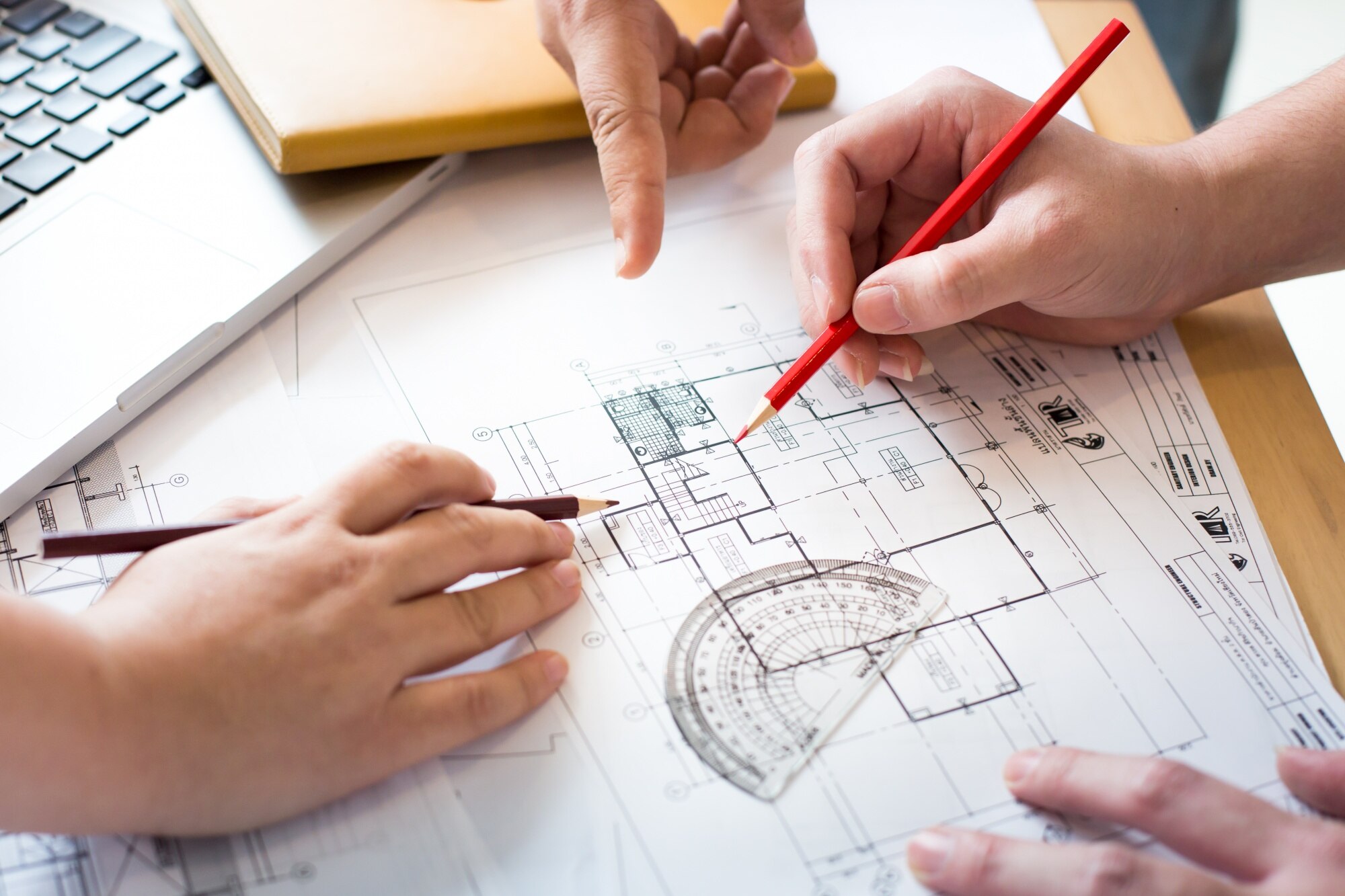 architects-discussing-table-with-blueprint-closeup-hands-project-print_1423-269
